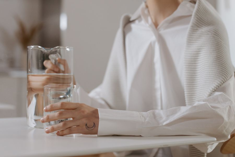 A person holding a glass of water