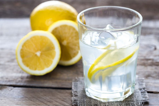 A glass of water with ice and lemons