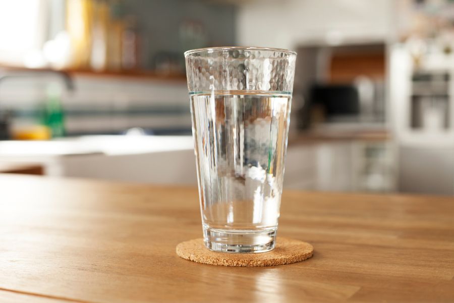 A glass of water on a coaster