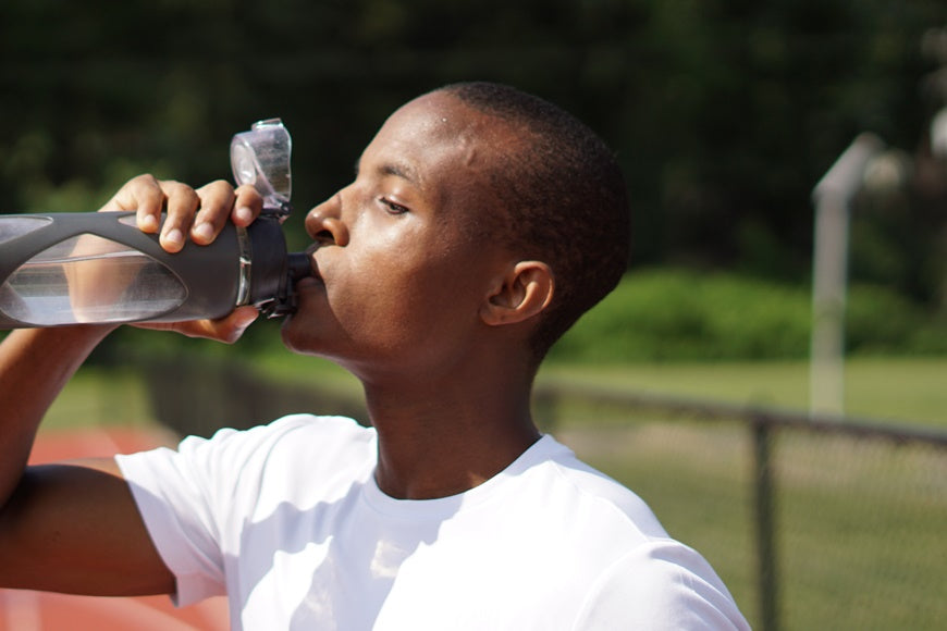 Young man drinking water from a bottle