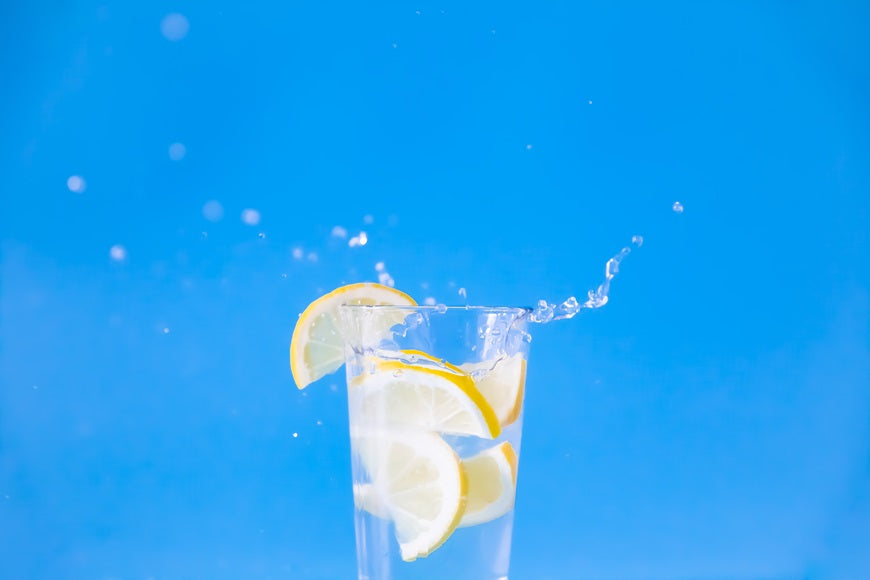 Glass with alkaline water and a lemon