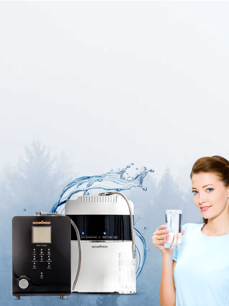A lady holding alkaline water in a glass standing next to Alkaline water ioniser machine